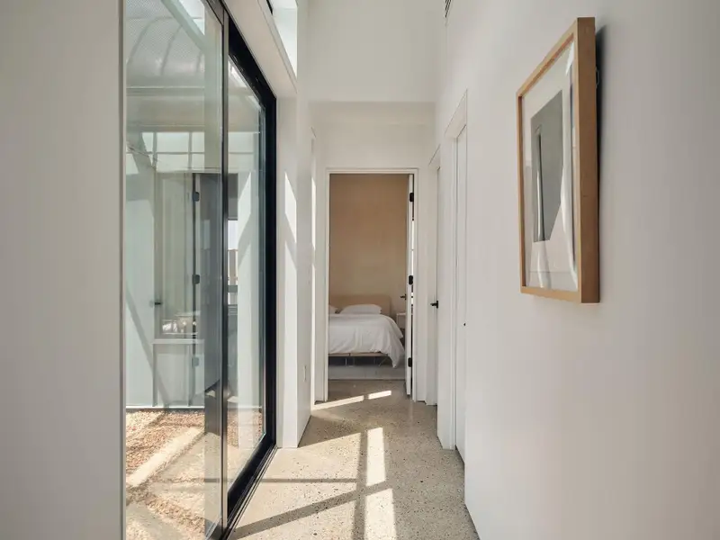 Corridor with polished concrete floors have been honed to reveal a terrazzo-like finish