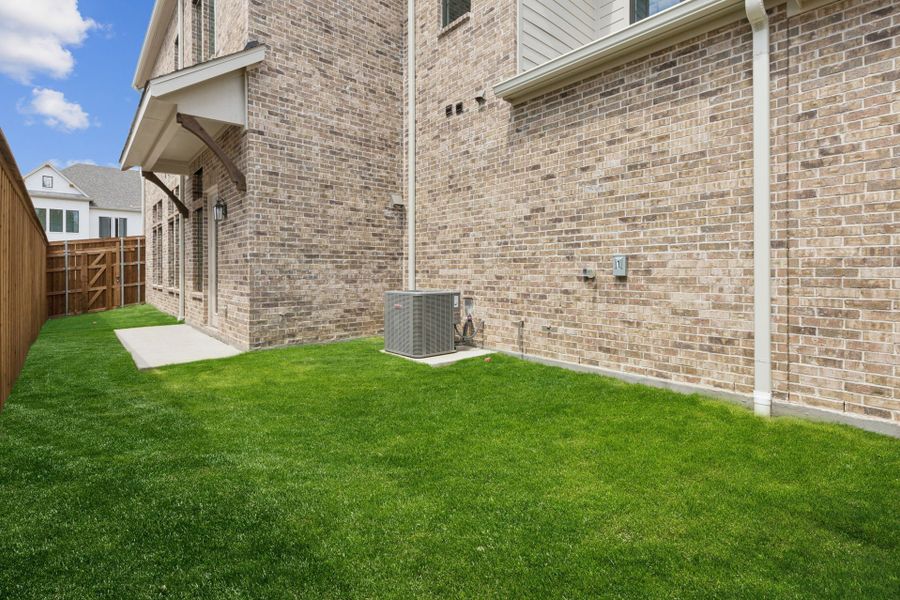 Exterior details and patio area of a home in Newman Village Townhomes, Frisco (Image 3).