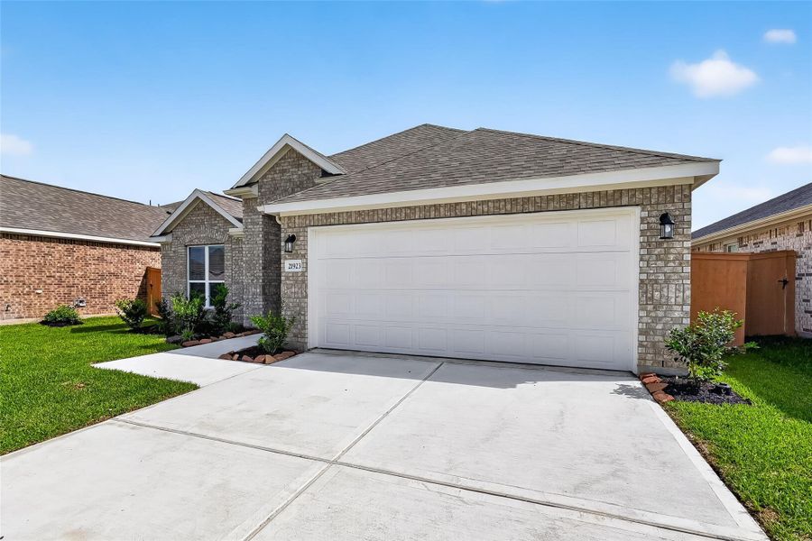 Front exterior of a new home in Grand Magnolia, Magnolia, TX, highlighting curb appeal (Image 22).