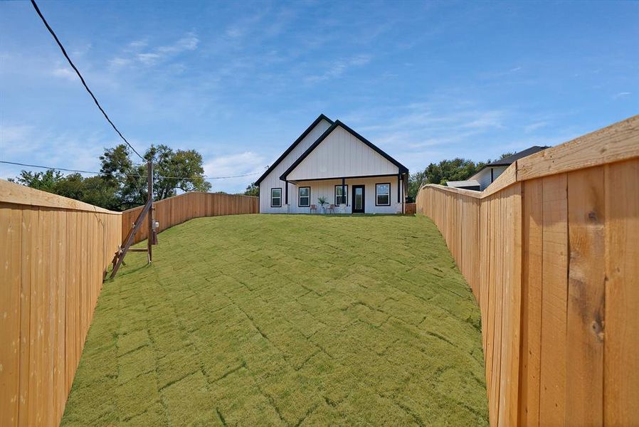 Back of house with a patio area and a fenced backyard Back of house with a patio area and a fenced backyard