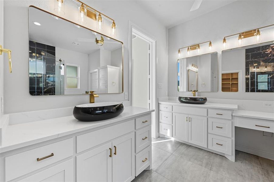 Full bathroom with two vanities, a shower stall, and light tile patterned flooring Full bathroom with two vanities, a shower stall, and light tile patterned flooring
