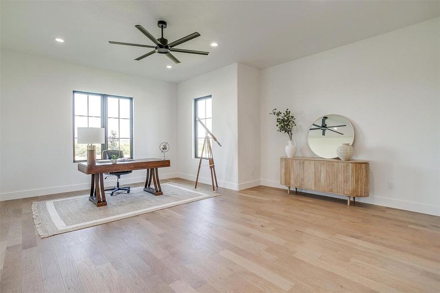 Office space featuring light hardwood / wood-style flooring and ceiling fan