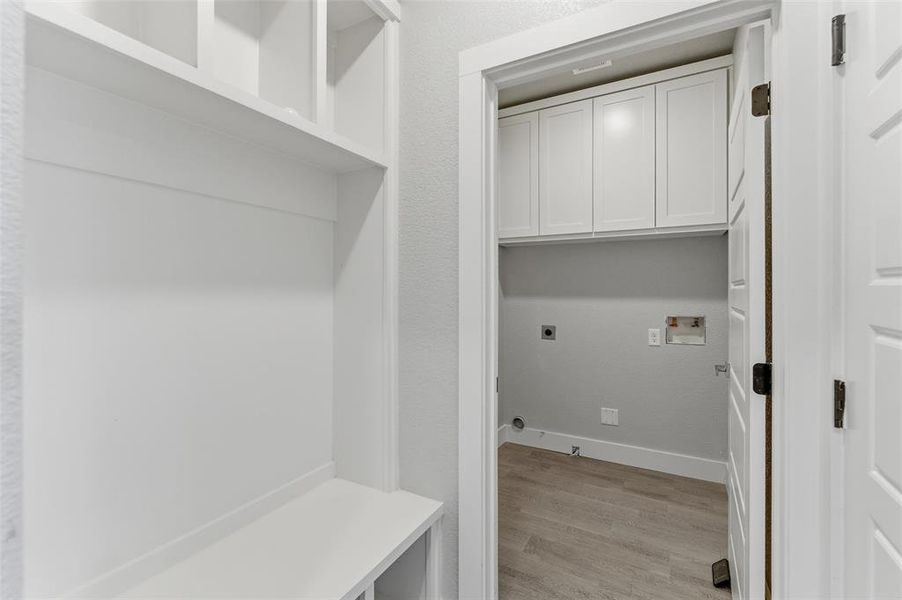 Mudroom entry from the garage with adjacent laundry area. Mudroom entry from the garage with adjacent laundry area.