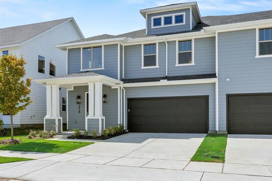 Front exterior of a new home in North Square at Uptown, Celina, TX, highlighting curb appeal (Image 1). Front exterior of a new home in North Square at Uptown, Celina, TX, highlighting curb appeal (Image 1).
