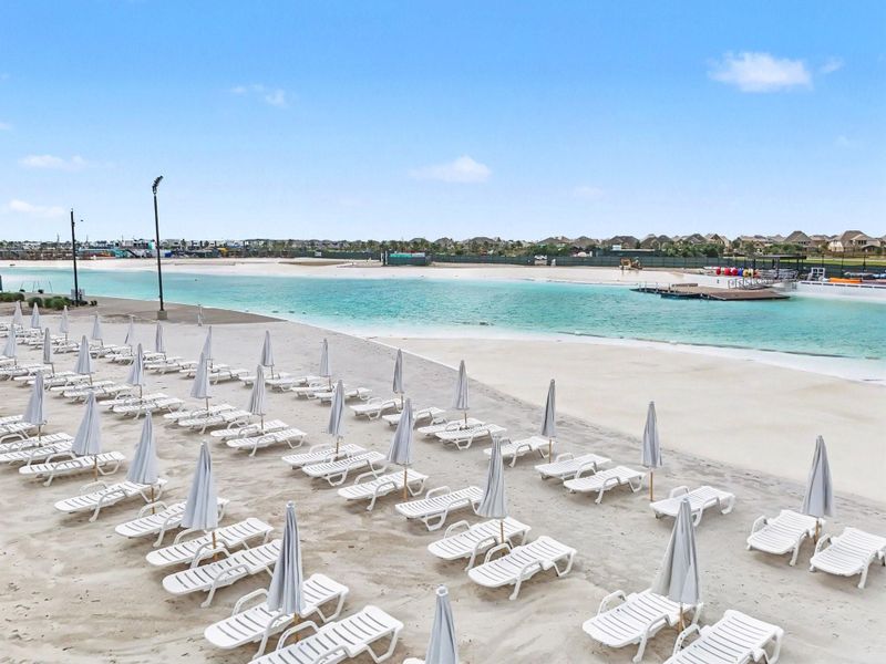Relax by the lagoon's sandy beach with lounge seating, creating a vacation-inspired setting just minutes from home. Relax by the lagoon's sandy beach with lounge seating, creating a vacation-inspired setting just minutes from home.
