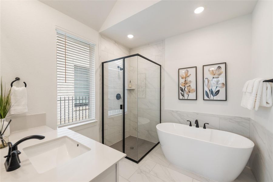 Luxurious soaking tub and sleek glass-enclosed shower create a rejuvenating bath space. Luxurious soaking tub and sleek glass-enclosed shower create a rejuvenating bath space.