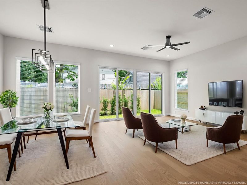 The ROCcreek features a bright, open living room and dining room spaces designed for effortless entertaining and stylish everyday comfort. Image depicts home as-is virtually staged.