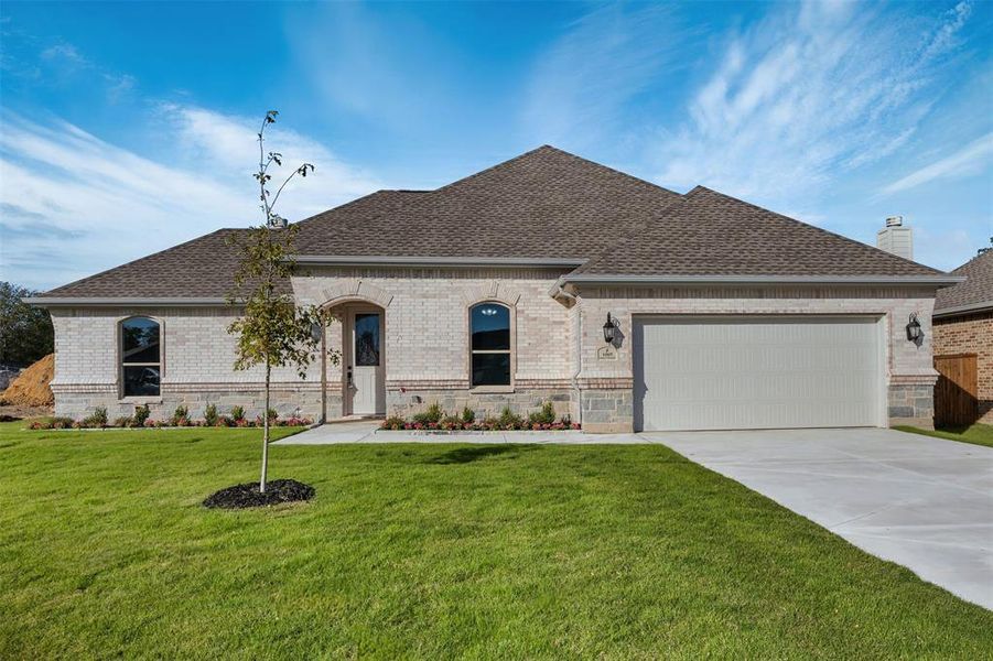 View of front of house featuring a garage and a front yard