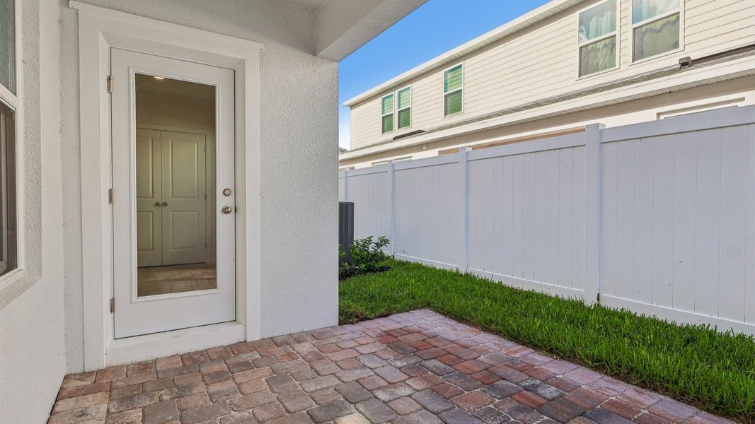 Exterior details and patio area of a home in Cyrene at Harmony, St. Cloud (Image 25).