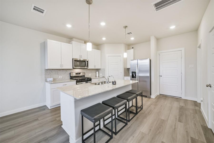 The island is a great place for additional high chair seating. The island is a great place for additional high chair seating.