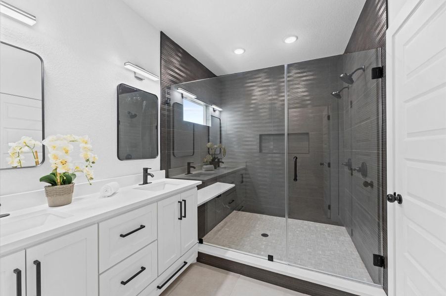 Take a look at the impressive frameless shower that boasts plenty of space and a convenient bench.