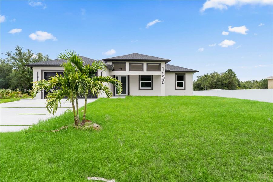 Front exterior of a new home in , Lehigh Acres, FL, highlighting curb appeal (Image 20). Front exterior of a new home in , Lehigh Acres, FL, highlighting curb appeal (Image 20).