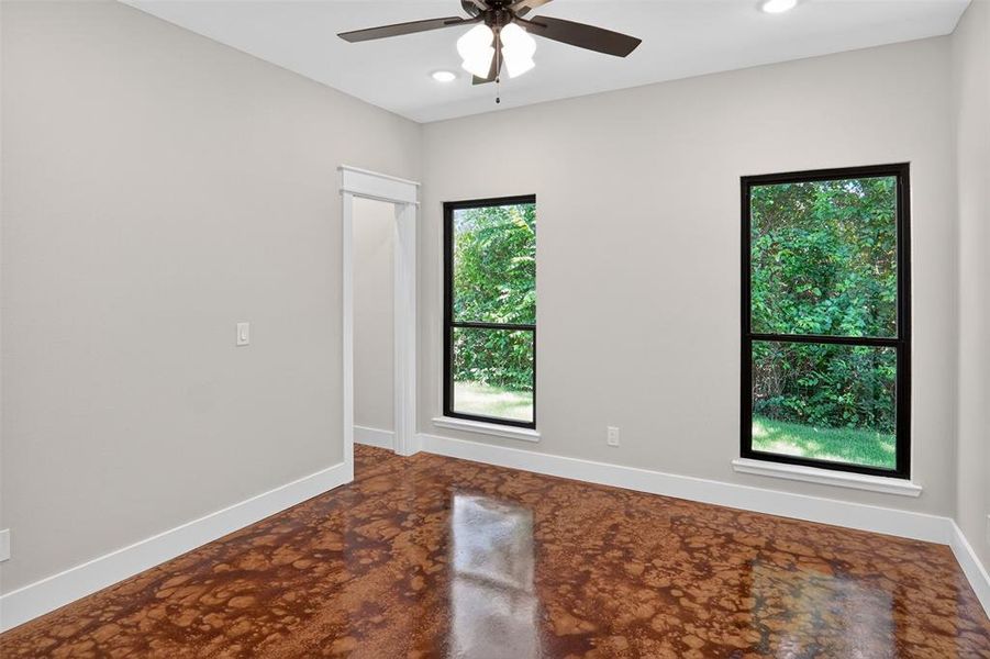 2nd primary Spacious room featuring patterned flooring, two large windows, a ceiling fan with integrated lighting, recessed lighting, and crisp white baseboards 2nd primary Spacious room featuring patterned flooring, two large windows, a ceiling fan with integrated lighting, recessed lighting, and crisp white baseboards