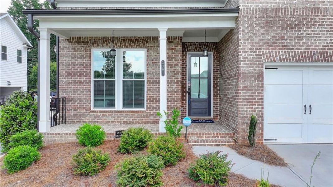 Front exterior of a new home in Ellington Townhomes, Suwanee, GA, highlighting curb appeal (Image 2).