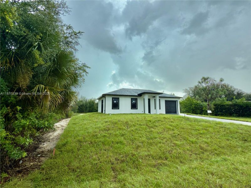 Front exterior of a new home in , Lehigh Acres, FL, highlighting curb appeal (Image 2). Front exterior of a new home in , Lehigh Acres, FL, highlighting curb appeal (Image 2).