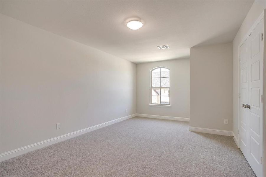 Spare room with baseboards and light colored carpet Spare room with baseboards and light colored carpet