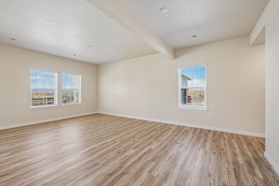A room with a wood floor and windows.