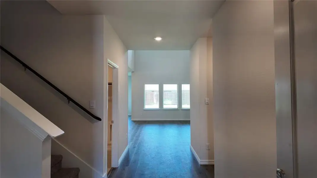 Corridor featuring dark wood-style floors and recessed lighting