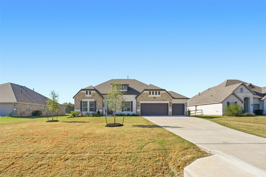 Front exterior of a new home in Tejas Landing, Needville, TX, highlighting curb appeal (Image 2). Front exterior of a new home in Tejas Landing, Needville, TX, highlighting curb appeal (Image 2).