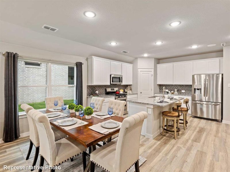 Dining space with light wood-type flooring and sink