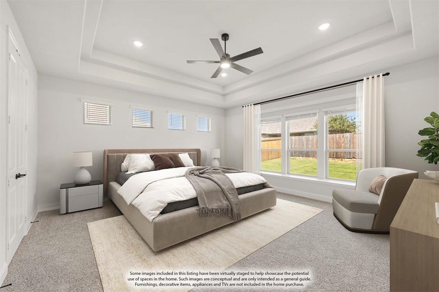 Spacious master bedroom with tray ceiling, ceiling fan, carpet flooring, and large windows overlooking backyard. Spacious master bedroom with tray ceiling, ceiling fan, carpet flooring, and large windows overlooking backyard.