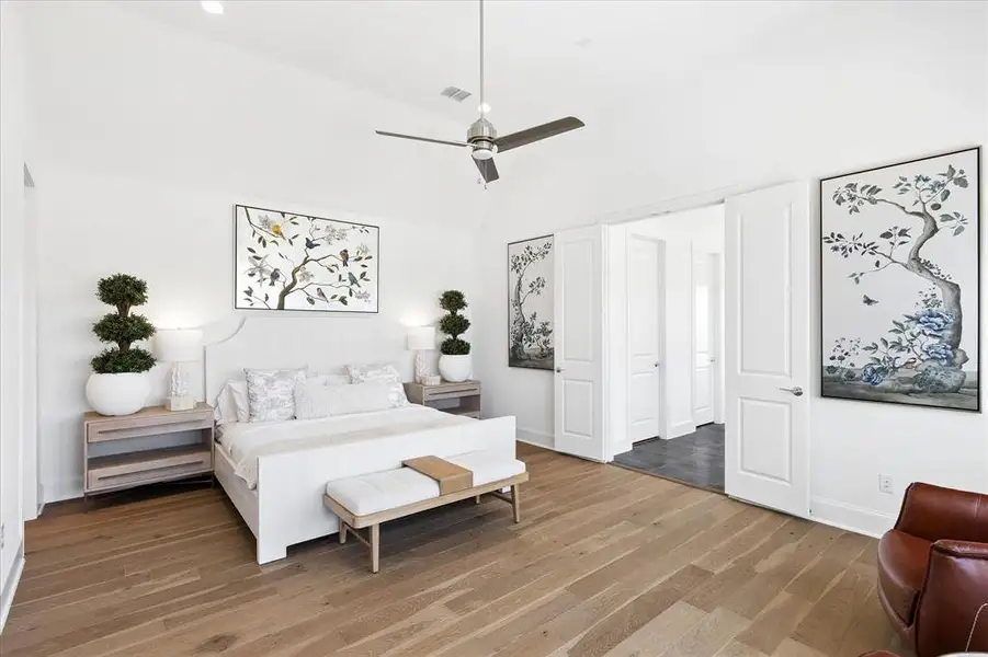 Vaulted ceiling with a contemporary ceiling fan, wood-finish flooring, white paneled doors, and recessed lighting