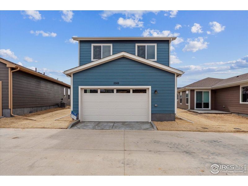 Front exterior of a new home in Parkway at Prairie Center Village, Brighton, CO, highlighting curb appeal (Image 2).