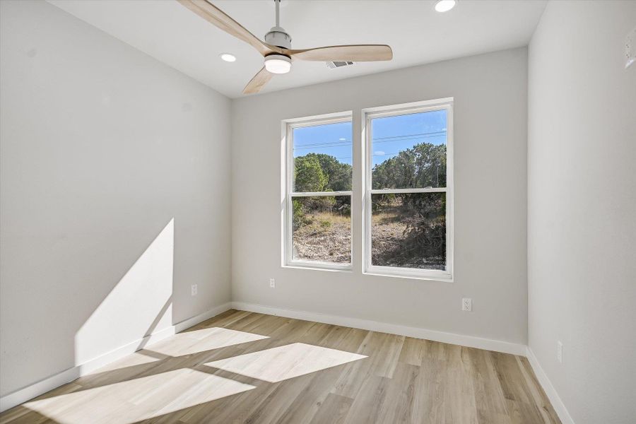 Unfurnished room with light wood-style floors, a ceiling fan, and recessed lighting