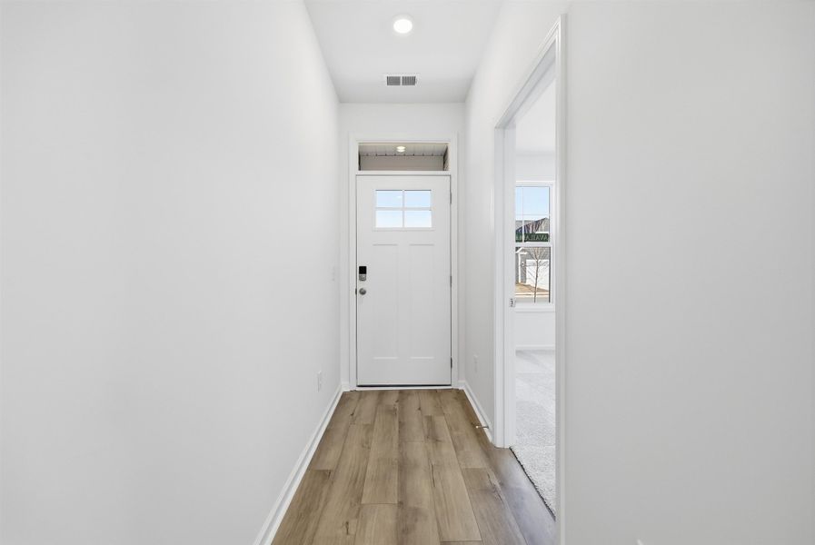 Entryway with wood finished floors and recessed lighting Entryway with wood finished floors and recessed lighting