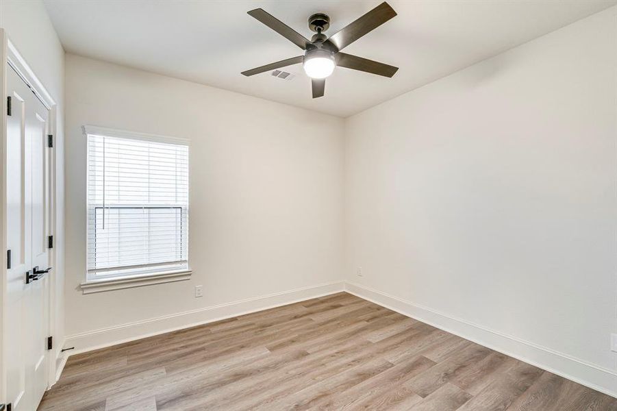 Unfurnished room featuring a ceiling fan, baseboards, and light wood-type flooring Unfurnished room featuring a ceiling fan, baseboards, and light wood-type flooring