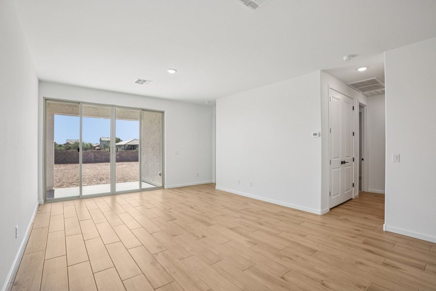 Great room with 4 panel slider. Finishes and options may vary by community.