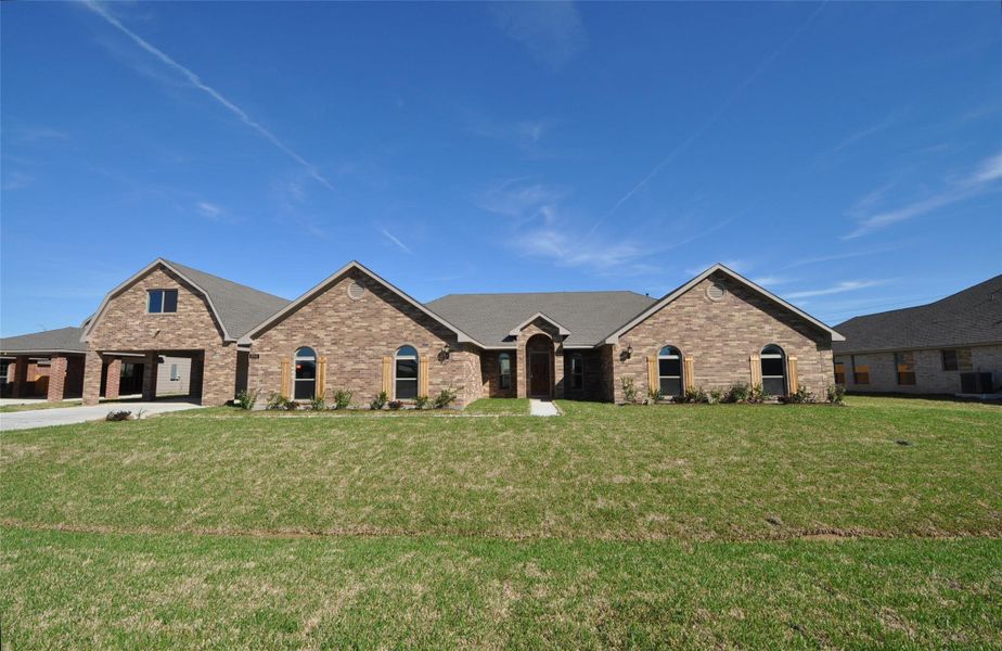 Front exterior of a new home in Pedregal, League City, TX, highlighting curb appeal (Image 26).