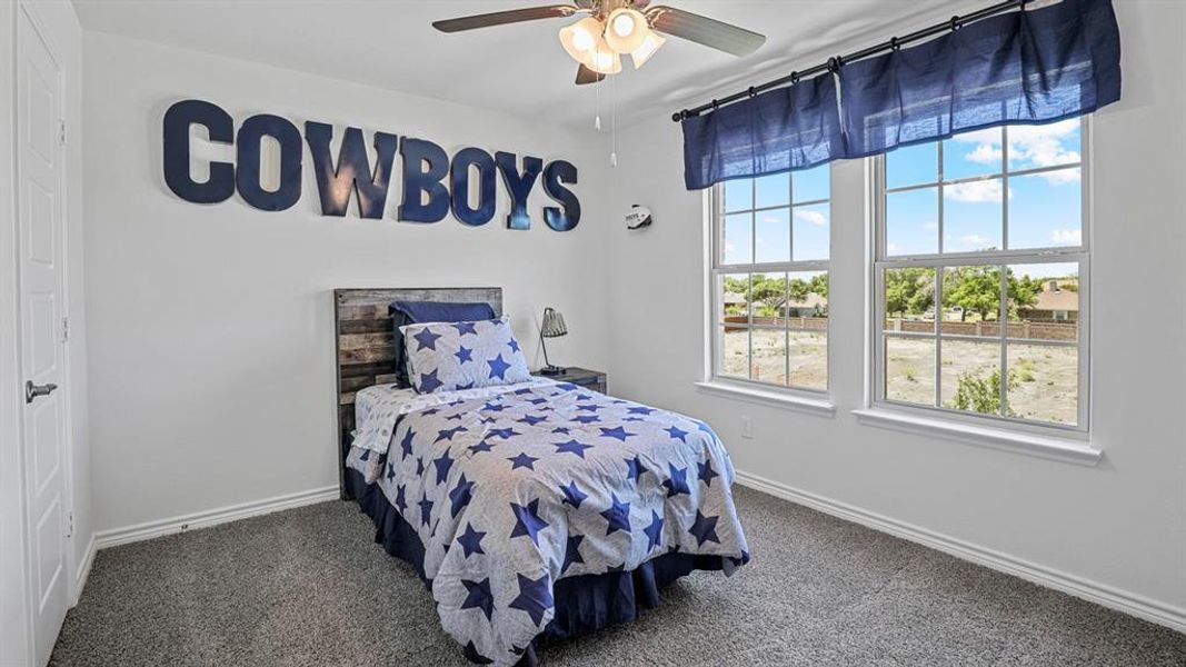 Bedroom with a ceiling fan and carpet floors