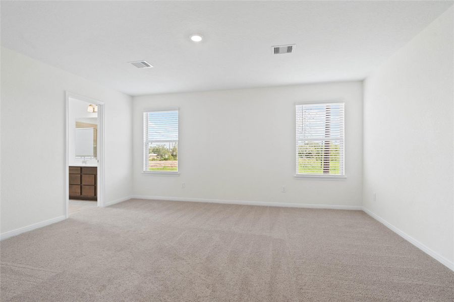Relax and unwind after a long day in this impressive primary suite! This generously sized room offers plush carpeting, warm-toned paint, high ceilings with recessed lighting, and large windows with privacy blinds for added comfort and tranquility. Relax and unwind after a long day in this impressive primary suite! This generously sized room offers plush carpeting, warm-toned paint, high ceilings with recessed lighting, and large windows with privacy blinds for added comfort and tranquility.