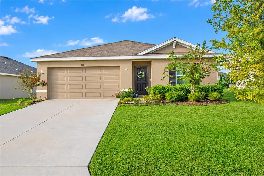 Front exterior of a new home in Fairways at Twisted Oaks, Beverly Hills, FL, highlighting curb appeal (Image 2).