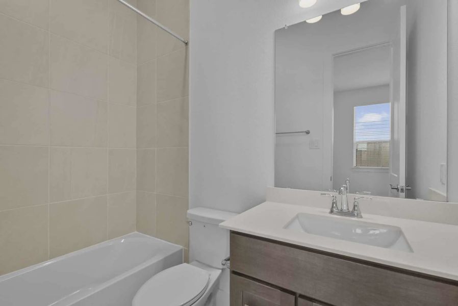 Representative furnished interior of a home built from the Nicklaus by Chesmar Homes in Riceland Alley Loads, Mont Belvieu (Image 42).