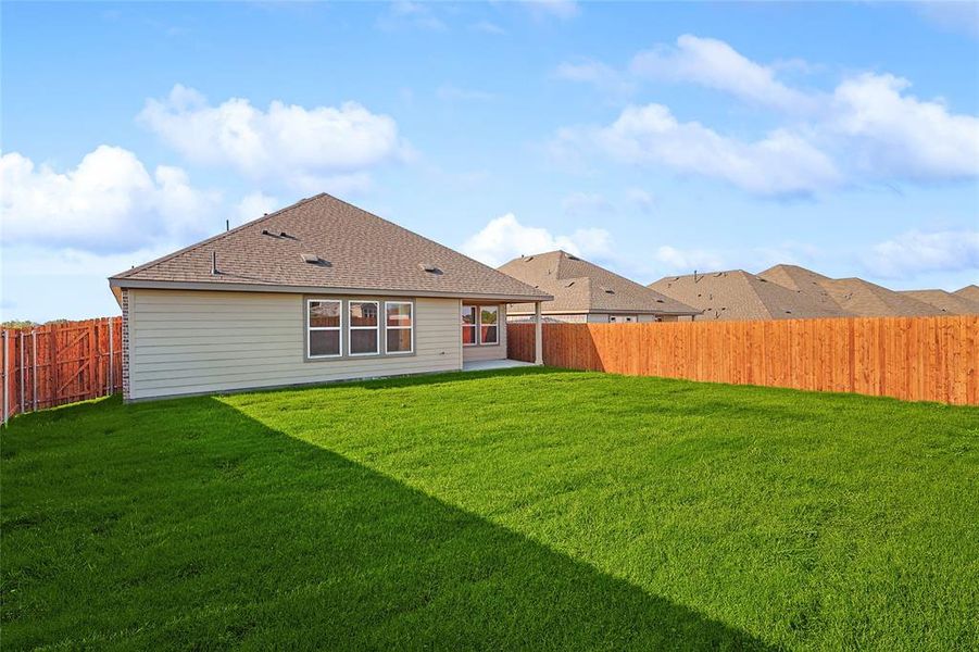 Rear view of house with a yard