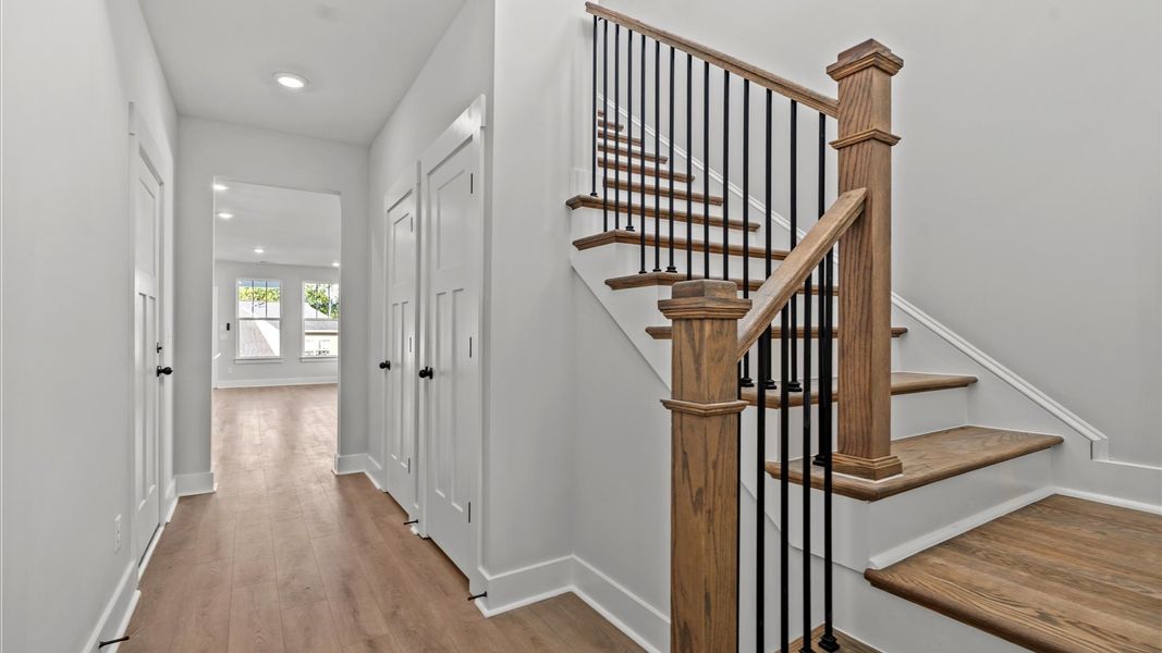 Exceptional foyer with warm hardwood flooring and refined finishes throughout