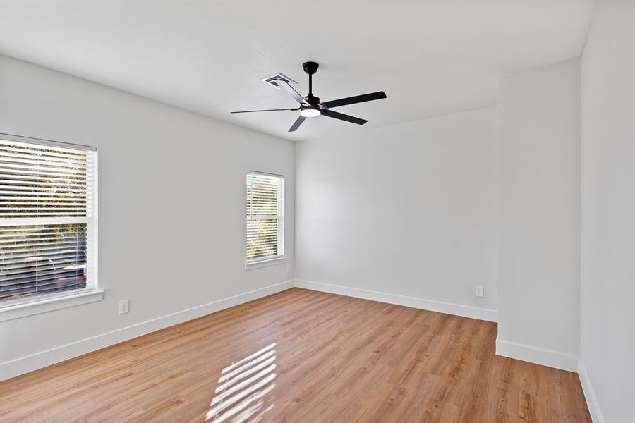 Spare room with ceiling fan and light wood-type flooring