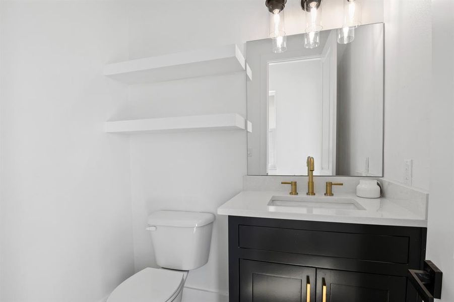 Half bathroom with vanity and toilet Half bathroom with vanity and toilet