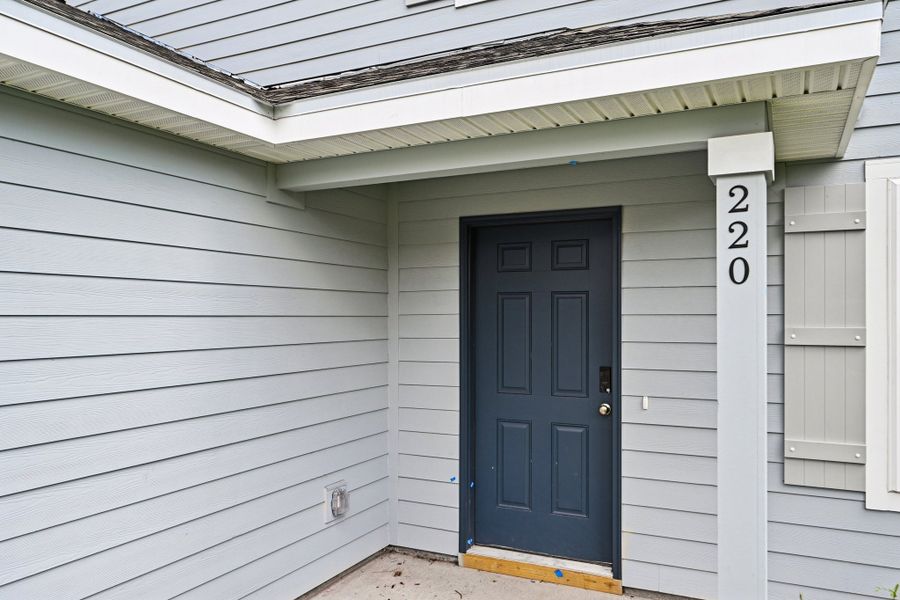 A white house with a blue door.