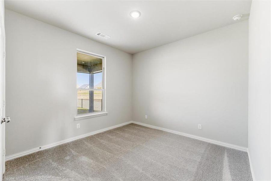 Empty room featuring carpet floors and baseboards