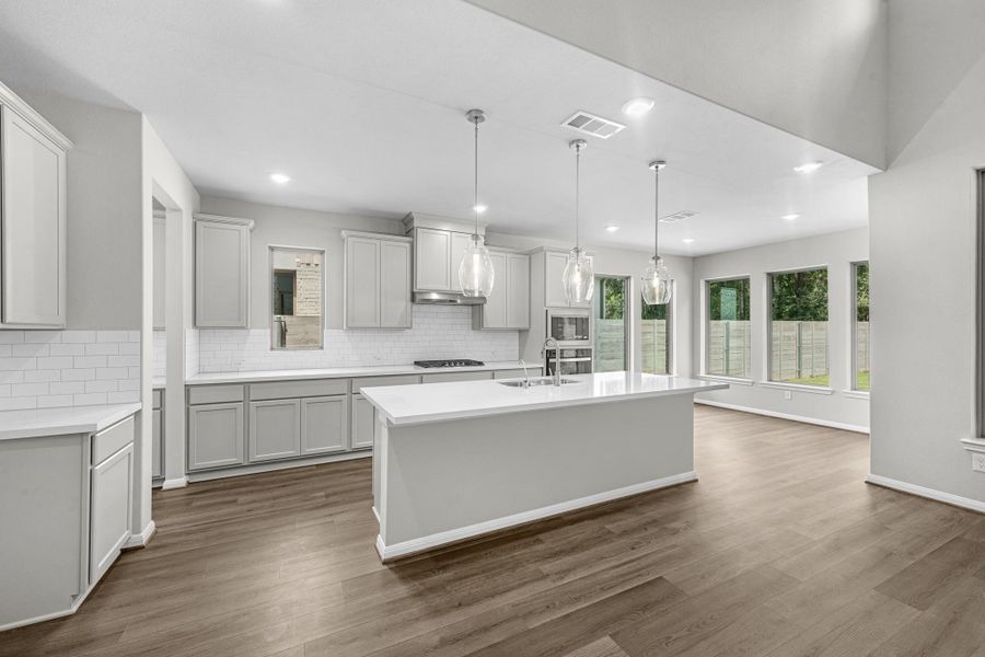 Seamless connection from the kitchen to the casual dining/breakfast area with stunning tree views.