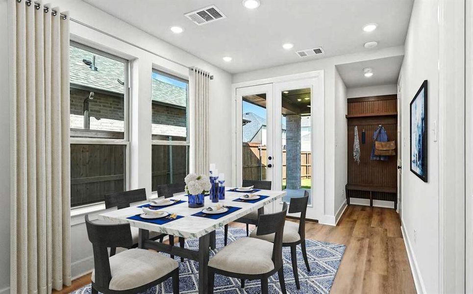Dining room featuring french doors, wood finished floors, and recessed lighting Dining room featuring french doors, wood finished floors, and recessed lighting