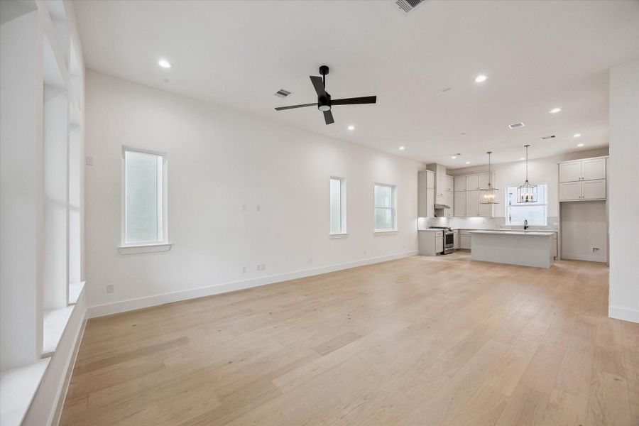 Beautiful view of one of Riverway Homes’ stunning kitchens and open-concept living areas.