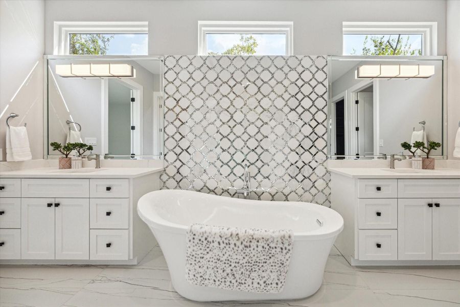 Primary Bathroom with elegant freestanding soaking tub and inlaid backsplash Primary Bathroom with elegant freestanding soaking tub and inlaid backsplash