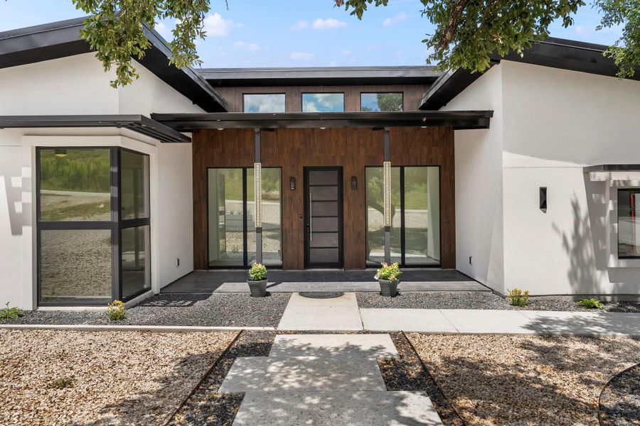 Doorway to property featuring stucco siding