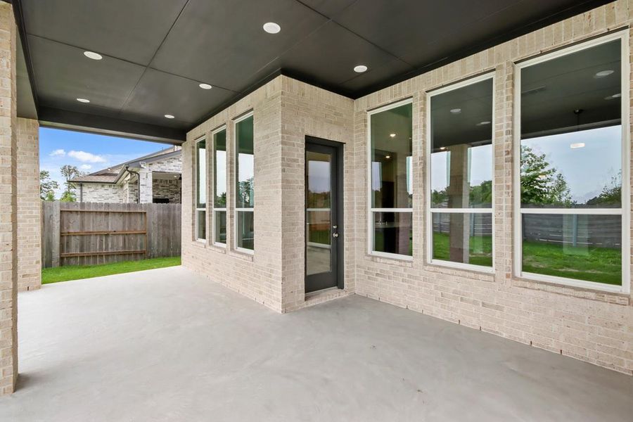 Exterior details and patio area of a home in ARTAVIA, Conroe (Image 18).