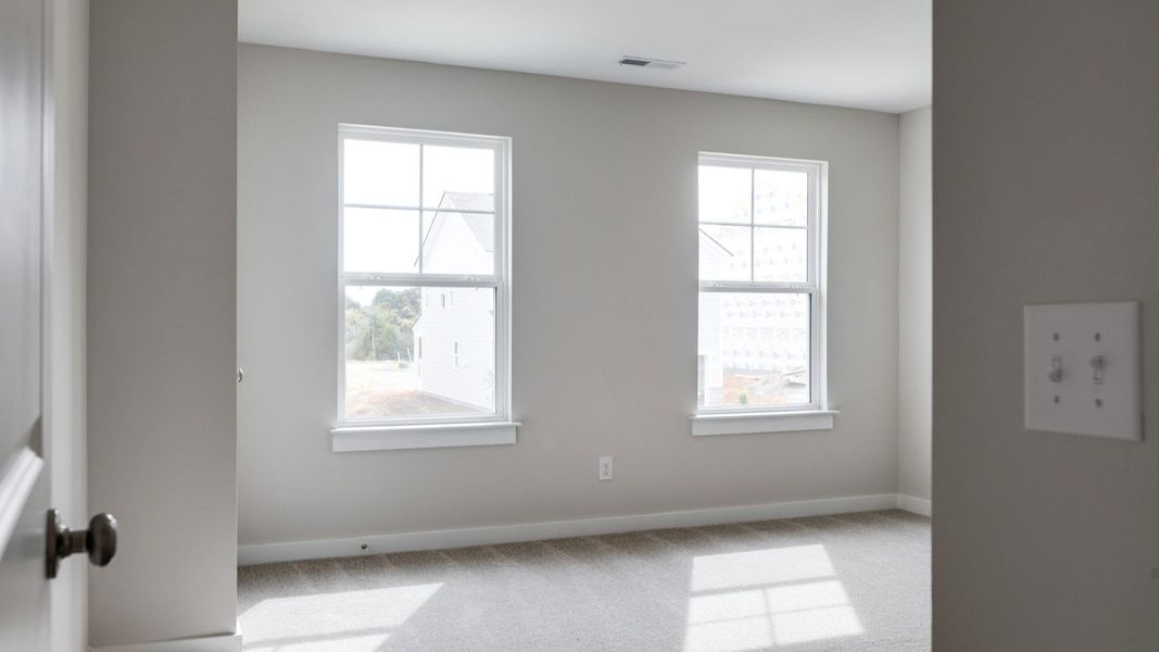 Spacious separate secondary bedroom with windows