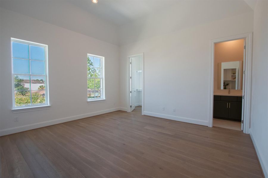 One of the large secondary bedrooms with wood flooring & vaulted ceiling One of the large secondary bedrooms with wood flooring & vaulted ceiling